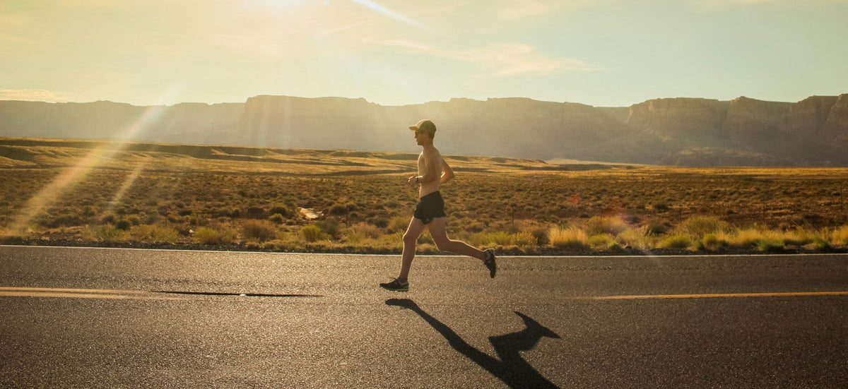 Coureur sur une route au lever du soleil